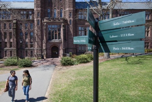 Two students walking on the path near the Williston library