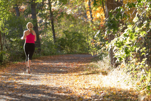 A student running on one of the campus trails