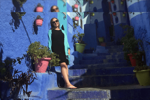 Maddie Fitzgerald leaning on a blue wall