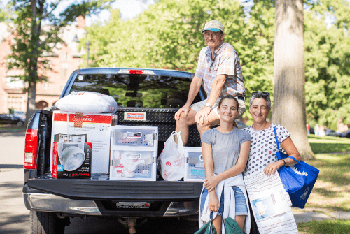 A famiy with a truck full of belongings on move-in day