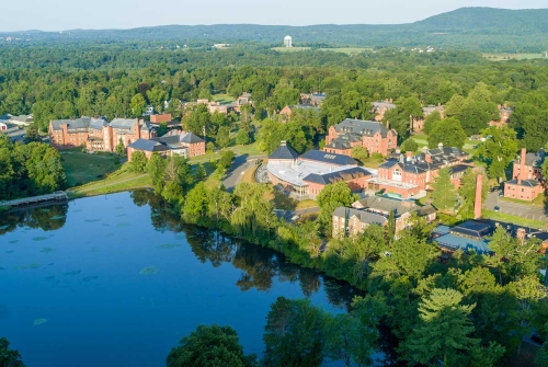 The Mount Holyoke Campus seen from above, with Lower Lake in the foreground and rolling hills in the background