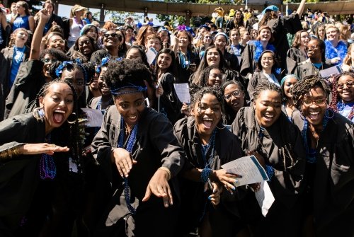 Students in blue cheer to the camera at Convocattion 2022.