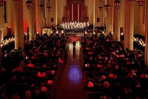 Vespers - students singing wearing all black and holding candles, 2023 in Abbey Memorial Chapel