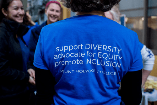 The back of a t-shirt with the saying "Support diversity, advocate for equity, promote inclusion"