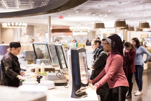 Students waiting while food is being prepared in the dining commons.