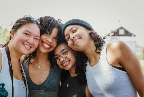 Group of students smile together atop the summit of Mount Holyoke