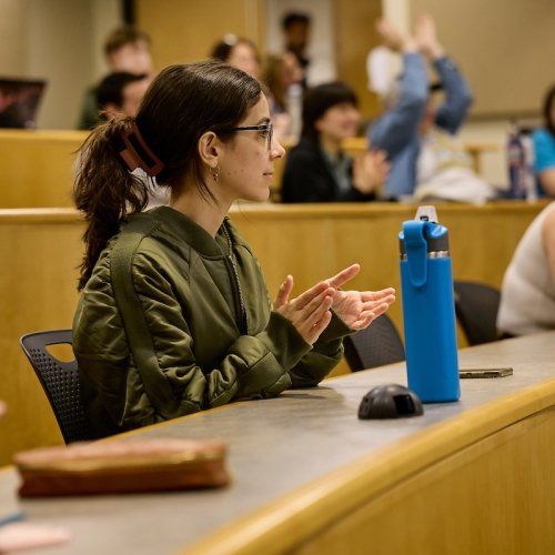 Student clapping in a lecture hall.