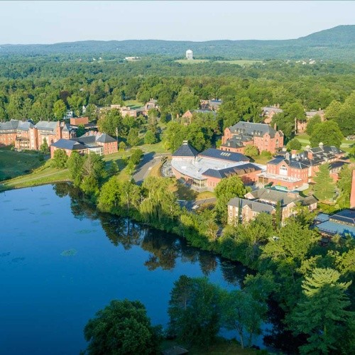 The Mount Holyoke Campus seen from above, with Lower Lake in the foreground and rolling hills in the background