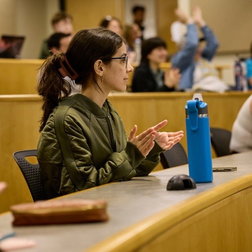 Student clapping in a lecture hall.