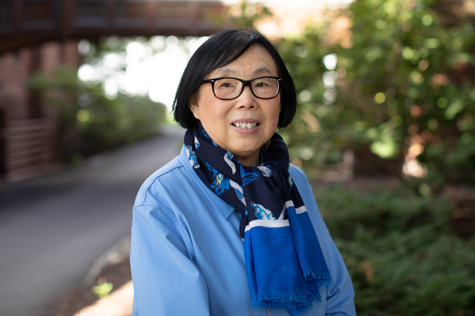 Ying Wang standing outside on the Mount Holyoke College campus