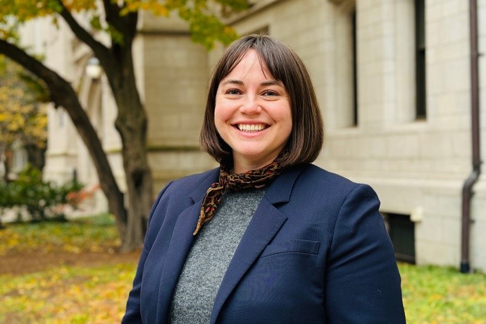 Anne Taylor (a woman wearing dark blue with short brown hair)