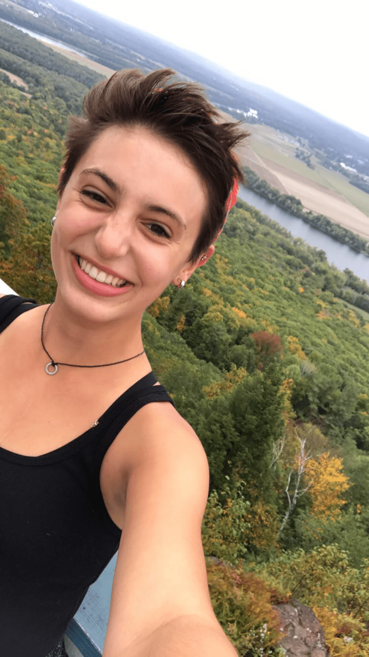 Isabel DiBiasio-Hudson atop Mount Holyoke on Mountain Day