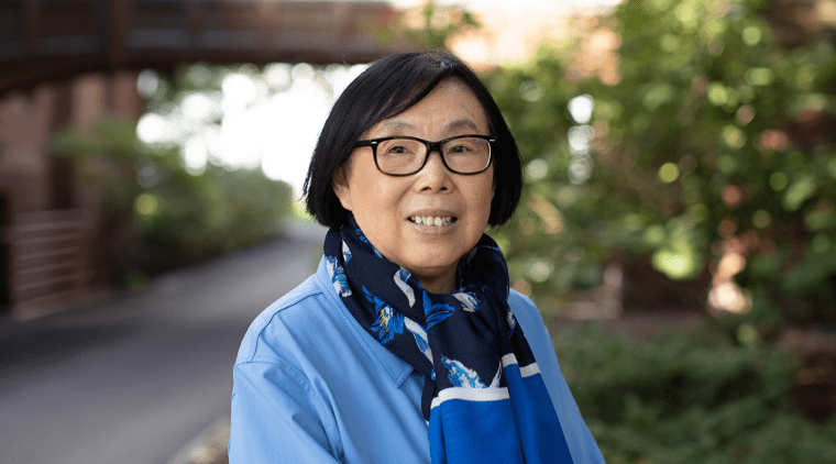 Ying Wang standing outside on the Mount Holyoke College campus