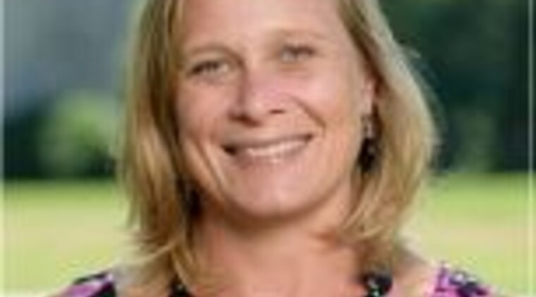 Amanda Mayfield, a woman with short blond hair wearing a black necklace and a pink and black top.