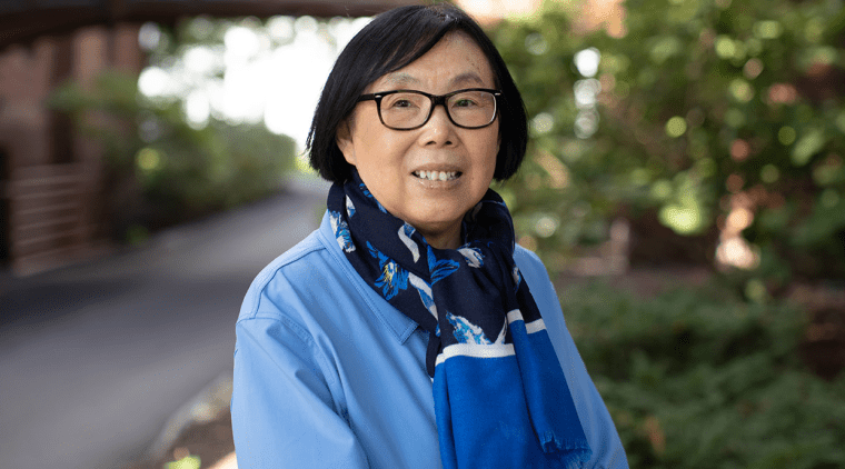 Ying Wang standing outside on the Mount Holyoke College campus
