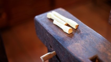 Erin Hancock carved missing pegs for barn-frame loom.