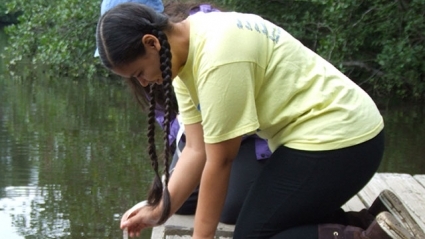 Jailene Rodriguez ’20 gauges water transparency during the Restoration Ecology Summer Scholars Program in 2014.