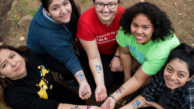 A group of students displaying their temporary tattoos on Mountain Day 2016.