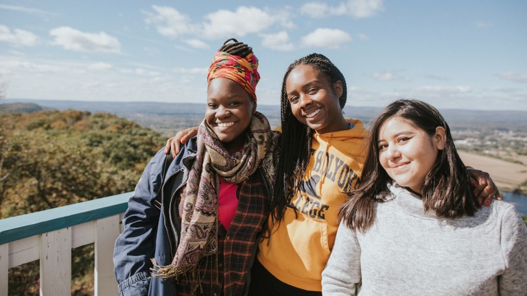 Three students on the deck of the Summit House atop Mount Holyoke on Mountain Day 2018.