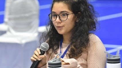 MHC Shakti student asking a question, holding a microphone