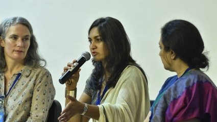 MHC Shakti - Three speakers, one holding a microphone talking