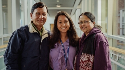 A student poses with their parents at LEAP 2018.