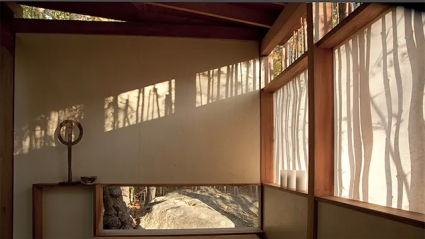 This is a view of part of the tea house that won Darling the AIA award in 2013. Vertical shadows play across semitransparent windows, weaving into wood patterns in the inetrior.