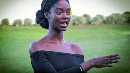 This is a photograph of Donari Yahzik in a black dress outside the US embassy in Apia, Somoa.