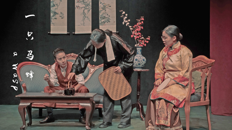 Three Asian characters on set in traditional dress.