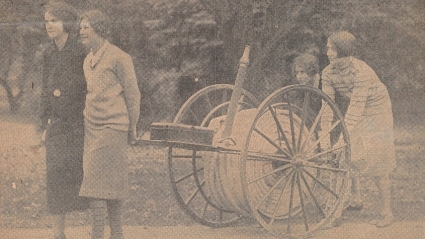 Members of Mount Holyoke’s fire brigade pull a large fire hose on a cart, 1920s.