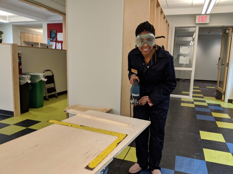 Student in the Fimbel Lab working on making the reception desk.