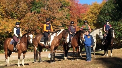 Riders on horseback during cross country day in the fall