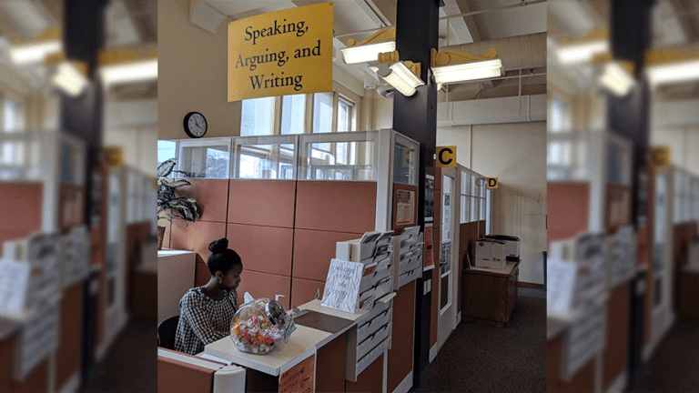 A student works at the SAW Cemter reception desk