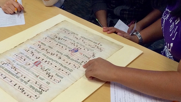 An archival sheet of music lying on a table