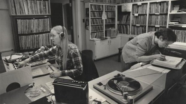 A student working as a DJ in a music booth