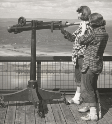 Mount Holyoke students searching the landscape at the Summit House atop Mount Holyoke in 1947.