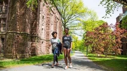 Donari Yahzid and friend walk a path through campus