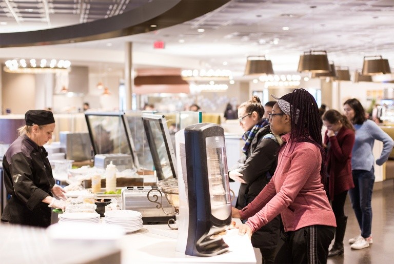 Students waiting while food is being prepared in the dining commons.