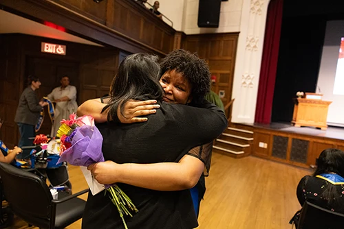 Mentor and mentee share a hug during the Stoling Ceremony at Mount Holyoke College