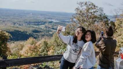 Two students take a selfie on the Summit House deck on Mount Holyoke College’s Mountain Day 2018.
