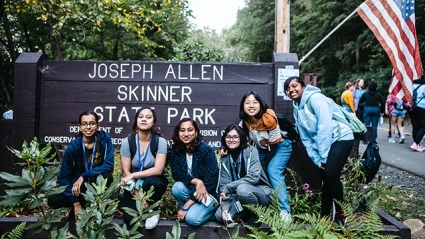 Students posing by the Joseph Allen Skinner State Park sign on Mountain Day