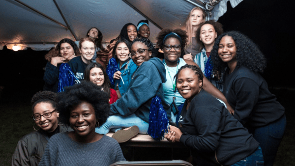 A group of students under the tent at Orientation