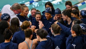 The swimming and diving team in a huddle