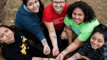 A group of students displaying their temporary tattoos on Mountain Day 2016.