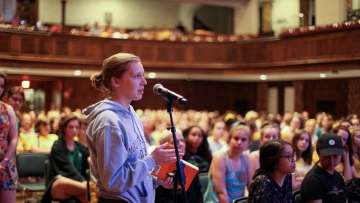 A student poses a question during the Common Read kickoff event