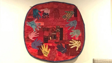 A colorful quilt that hangs in the Unity Center