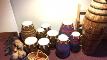 A collection of west african drums and other percussion instruments