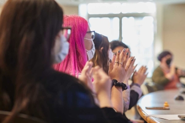 Students clapping during a presentation at Senior Symposium