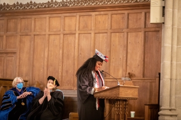 Zena Alhaj ’22 reading her poem at Baccalaureate