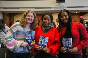 Three Mount Holyoke College students with Alafair Burke's book “Find Me”